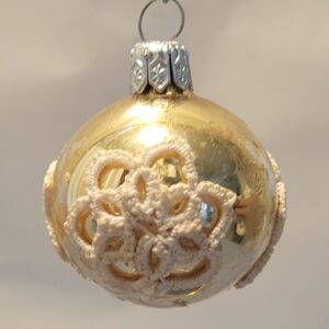 Handmade gold ornament featuring ivory tatted lace medallions. Elegant vintage-inspired Christmas and cottage décor.