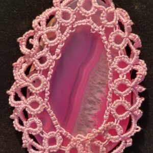 Pink agate pendant encircled by delicate lace