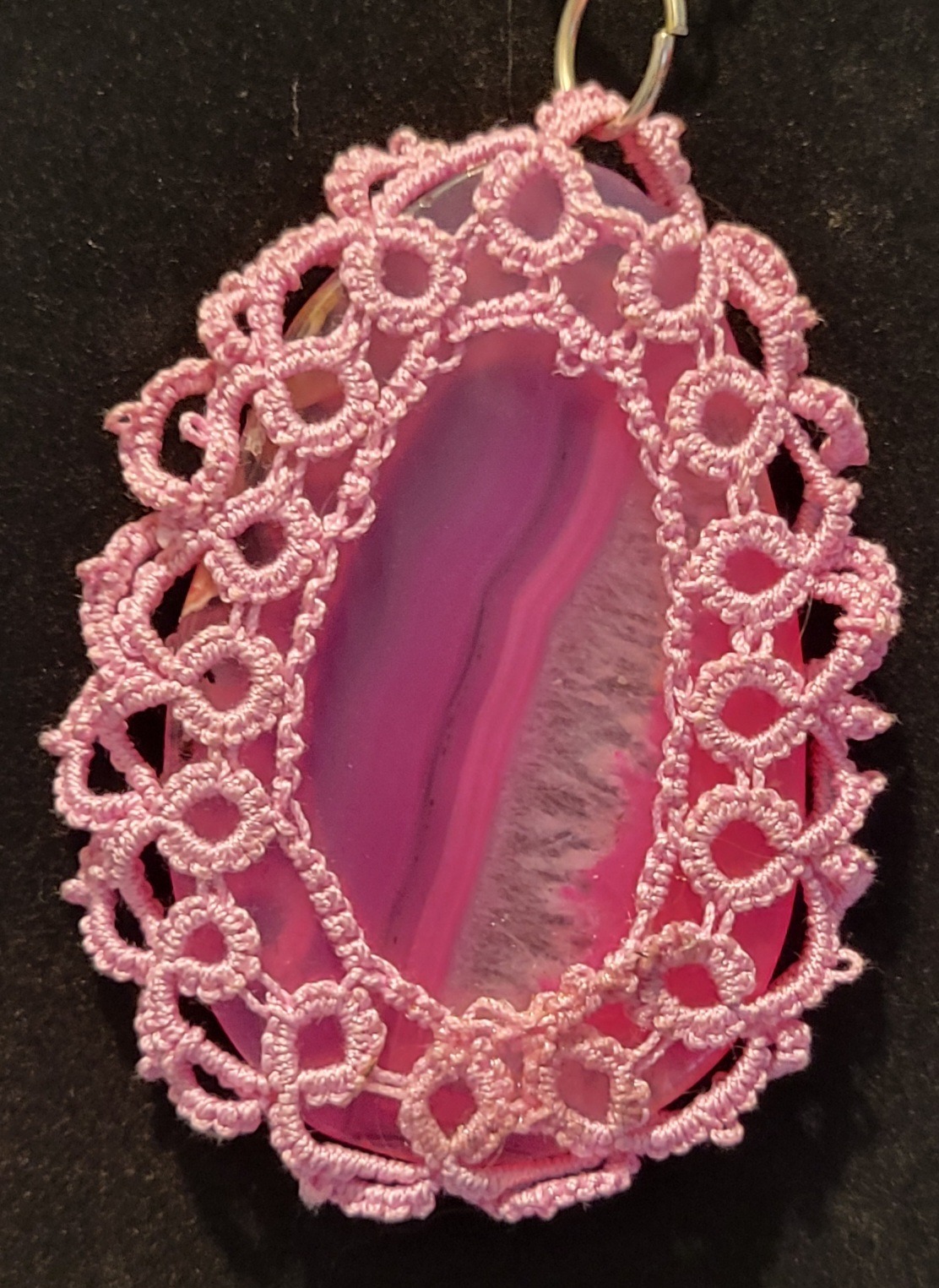 Pink agate pendant encircled by delicate lace