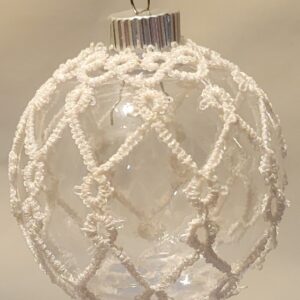 Clear glass ornament covered with delicate white hand-tatted lace in an intricate frosted lattice pattern.