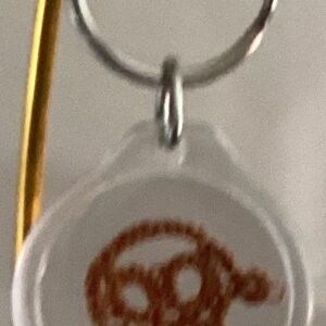 Clear acrylic keychain featuring a warm brown tatted turtle design with silver key ring.