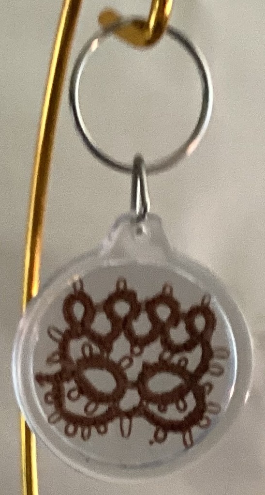 Clear acrylic keychain featuring a chestnut brown tatted paw print design with silver key ring.