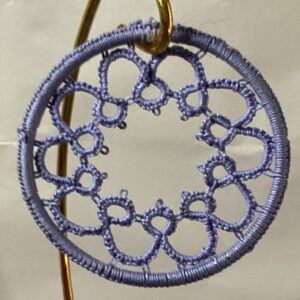 Hand-tatted Wedgwood blue lace mandala with floral-inspired detailing suspended inside a matching wrapped 3-inch hoop.