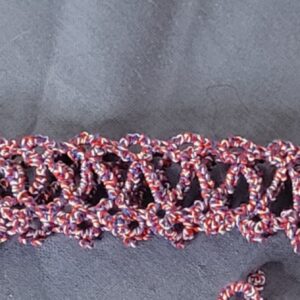 Hand-tatted patriotic lace hat band in variegated red, white, and blue with an intricate openwork design.