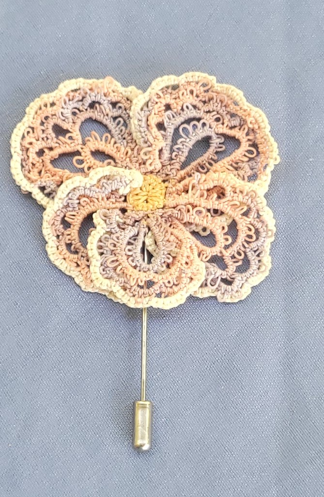 Hand-tatted autumn blossom hat and lapel pin in peach, cream, taupe, and gold with intricate floral lace design