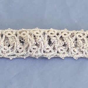 Silver-white hand-tatted lace hat band with intricate repeating pattern