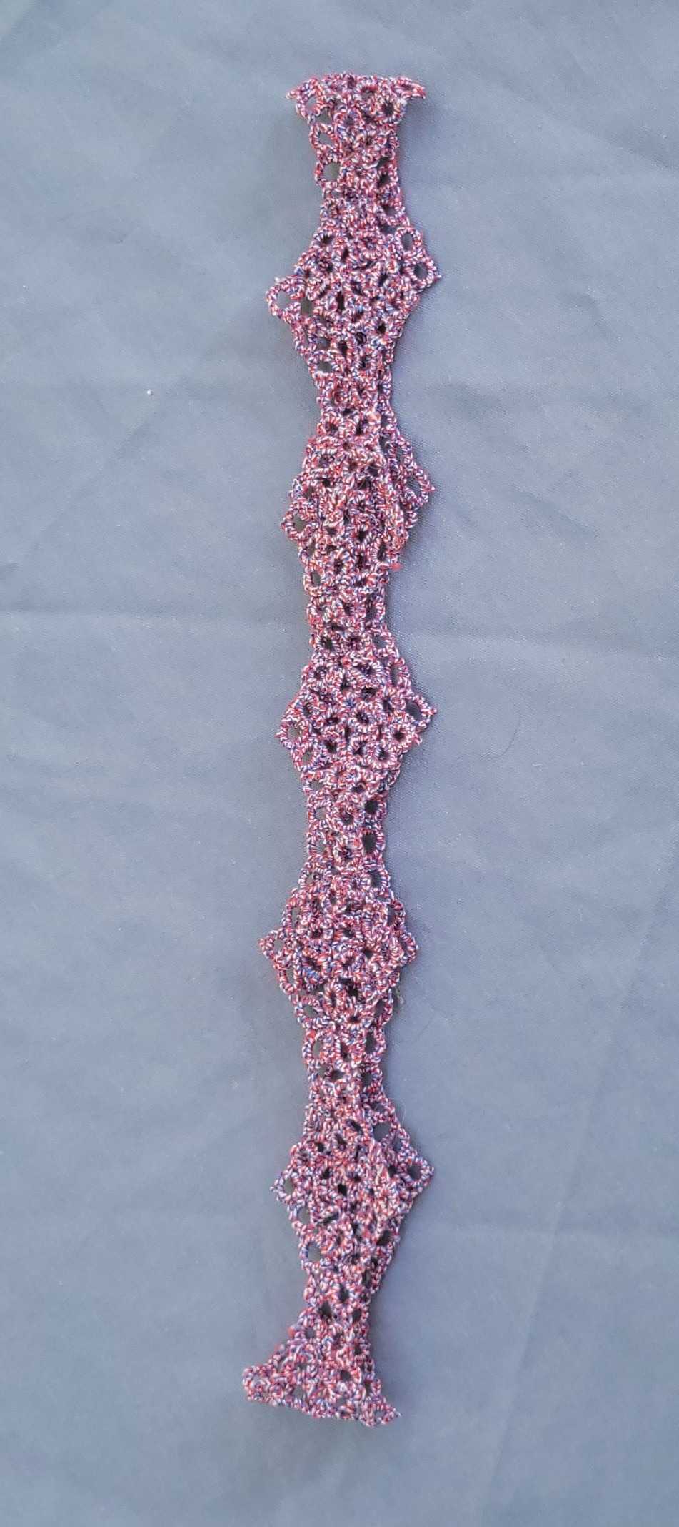 Red, white, and blue hand-tatted lace hat band made with Size 20 thread and featuring an intricate repeating pattern