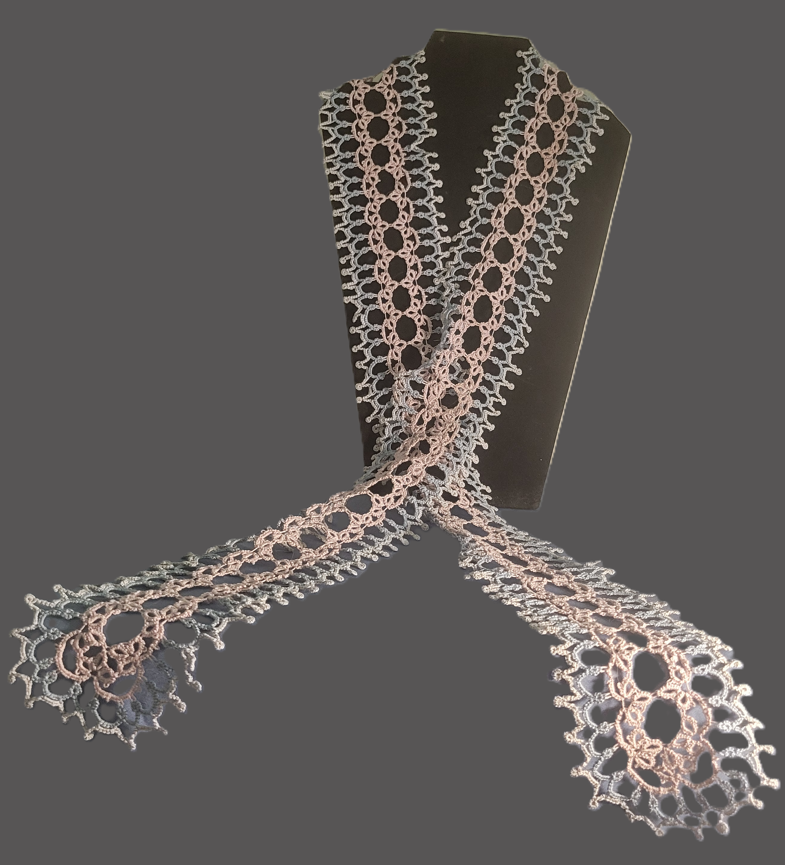 Handmade dusty rose and silvery gray tatted lace scarf displayed on a black mannequin, showing intricate openwork and scalloped picot edging.