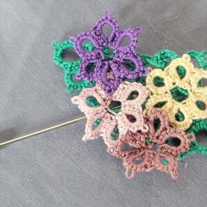 Hand-tatted Wildflower Meadow hat and lapel pin with layered purple, pink, green, cream, and brown flowers