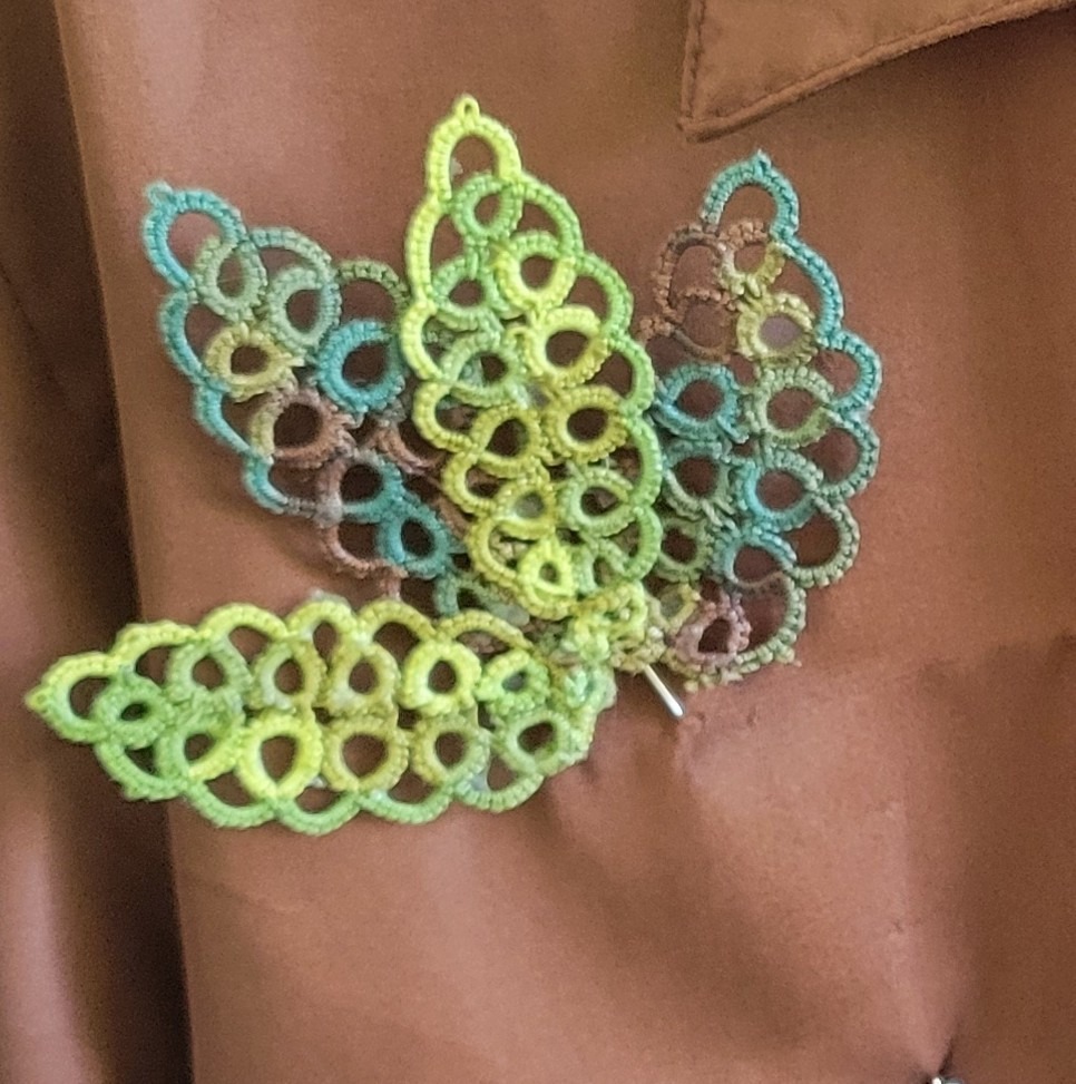 Summer Garden hand-tatted hat and lapel pin featuring layered lime green, aqua, and taupe leaf motifs