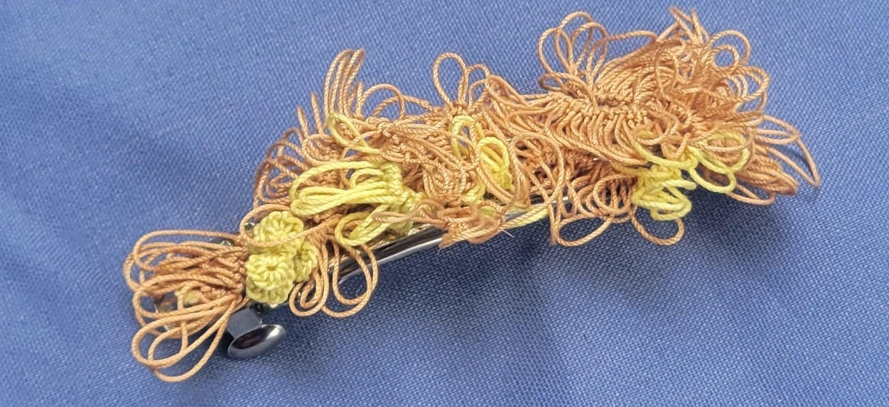 Sunlit Meadow hand-tatted lace barrette in tan, golden brown, and yellow-green with intricate floral and leafy motifs, approximately 1.75 inches long.