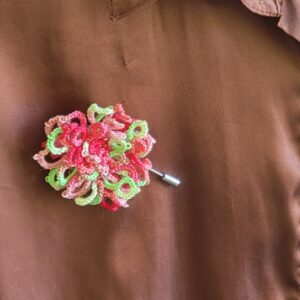 Wildflower Garden hand-tatted hat and lapel pin featuring colorful pink, red, green, and pastel flowers