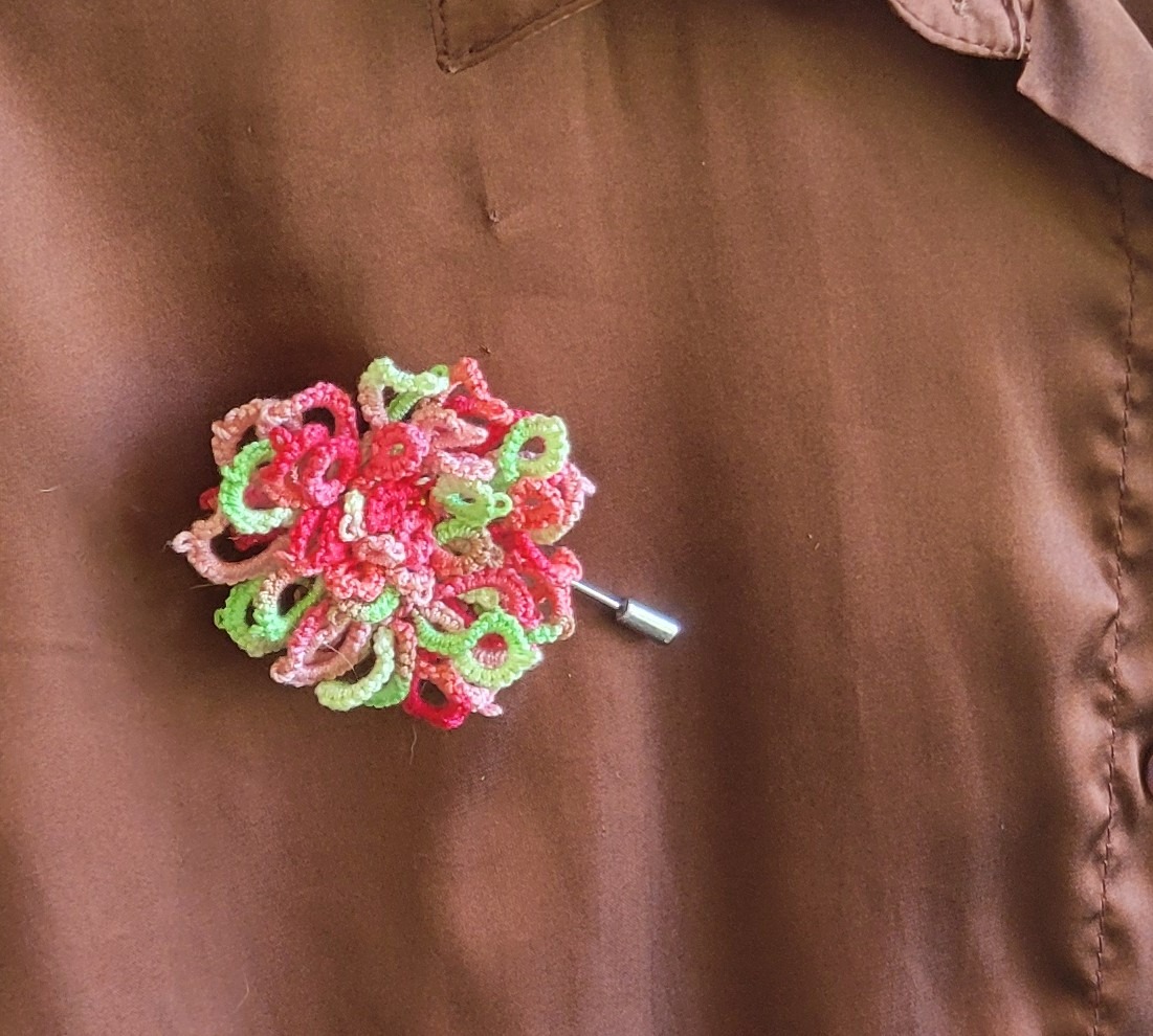 Wildflower Garden hand-tatted hat and lapel pin featuring colorful pink, red, green, and pastel flowers